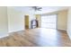 Bedroom with wood floors, ceiling fan and sliding glass doors to balcony at 6332 Newtown Cir # 32B2, Tampa, FL 33615