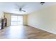 Spacious bedroom with ceiling fan, wood floors and sliding glass doors at 6332 Newtown Cir # 32B2, Tampa, FL 33615