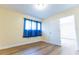 Bedroom featuring a window with curtains and a door that allows you to see into another room at 6332 Newtown Cir # 32B2, Tampa, FL 33615