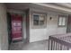 Exterior entrance to condo with a solid, secure red door at 6332 Newtown Cir # 32B2, Tampa, FL 33615