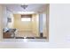 View of kitchen with tile floors and pass through from the dining area at 6332 Newtown Cir # 32B2, Tampa, FL 33615