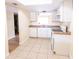 Bright kitchen featuring white cabinetry, tile floors, and modern appliances at 6332 Newtown Cir # 32B2, Tampa, FL 33615
