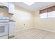 Bright kitchen with white cabinets, and tile flooring for easy cleaning at 6332 Newtown Cir # 32B2, Tampa, FL 33615