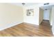 Bright living room with pass through to the kitchen and wood floors at 6332 Newtown Cir # 32B2, Tampa, FL 33615