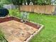 Landscaped backyard with a small garden with flowers and a paved patio at 6781 121St Ave # H, Largo, FL 33773
