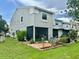 Home backyard with a screened-in patio, garden, and lawn at 6781 121St Ave # H, Largo, FL 33773