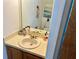 Well-lit bathroom featuring a single sink vanity, mirror, and toilet at 6781 121St Ave # H, Largo, FL 33773