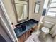 Bathroom featuring a toilet, and a dark blue sink with mirror and wood vanity at 6781 121St Ave # H, Largo, FL 33773