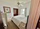 Bedroom featuring a queen bed, ceiling fan, and closet with a window view at 6781 121St Ave # H, Largo, FL 33773
