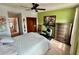 Bedroom featuring an exercise bike, dresser, painting, and closet at 6781 121St Ave # H, Largo, FL 33773