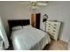 Bedroom features a bed, white dresser, and ceiling fan at 6781 121St Ave # H, Largo, FL 33773
