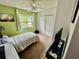 Bright bedroom featuring a window view, ceiling fan, and closet at 6781 121St Ave # H, Largo, FL 33773