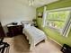 Bedroom featuring a bed, a window view, and natural light at 6781 121St Ave # H, Largo, FL 33773