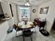Cozy dining area featuring a round table, four chairs, and natural light at 6781 121St Ave # H, Largo, FL 33773