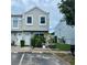 Charming townhome featuring a modern facade, well-maintained landscaping, and reserved parking at 6781 121St Ave # H, Largo, FL 33773