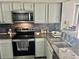 The kitchen features stainless steel appliances and granite countertops at 6781 121St Ave # H, Largo, FL 33773