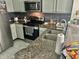 The kitchen features stainless steel appliances and granite countertops at 6781 121St Ave # H, Largo, FL 33773
