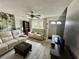 Inviting living room with a large window, ceiling fan, and comfortable sofas at 6781 121St Ave # H, Largo, FL 33773