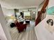 Open-concept living room featuring wood-look floors, a ceiling fan, and a staircase at 6781 121St Ave # H, Largo, FL 33773