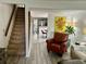 Inviting living room with staircase and view of the eat-in kitchen, bathed in natural light at 6781 121St Ave # H, Largo, FL 33773