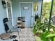 Enclosed patio with a chair and various potted plants at 6781 121St Ave # H, Largo, FL 33773