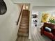 Carpeted staircase leading to the upper level, with views of the adjacent living spaces at 6781 121St Ave # H, Largo, FL 33773