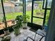 Enclosed sunroom with tile floors and a variety of plants at 6781 121St Ave # H, Largo, FL 33773