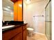 A bathroom featuring updated granite countertop, tiled floor and a glass door shower at 720 Lyndhurst St # 1104, Dunedin, FL 34698