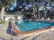 Community swimming pool surrounded by lush landscaping and seating at 720 Lyndhurst St # 1104, Dunedin, FL 34698