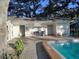 Community pool house with bench and beautiful landscaping at 720 Lyndhurst St # 1104, Dunedin, FL 34698