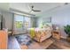 Stylish bedroom with tray ceiling, tropical decor, comfortable bedding, and an abundance of natural light at 7683 Summerland Cv, Lakewood Ranch, FL 34202