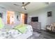 Comfortable bedroom featuring a ceiling fan, ensuite bathroom, walk-in closet, and neutral colors at 7683 Summerland Cv, Lakewood Ranch, FL 34202