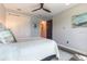 Comfortable bedroom with neutral decor, ceiling fan, and access to closet and ensuite bathroom at 7683 Summerland Cv, Lakewood Ranch, FL 34202