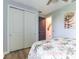 Bedroom showcasing wood floors, a ceiling fan, and a closet with white sliding doors at 7683 Summerland Cv, Lakewood Ranch, FL 34202