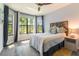 Inviting bedroom with abundant natural light, ceiling fan, and warm wood accents at 7683 Summerland Cv, Lakewood Ranch, FL 34202