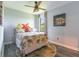 Bright bedroom featuring a ceiling fan, wood floors, and vibrant tropical-themed decor at 7683 Summerland Cv, Lakewood Ranch, FL 34202