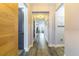 Hallway with light-colored walls, wood-look floors, and white trim leading to other rooms at 7683 Summerland Cv, Lakewood Ranch, FL 34202