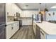 Well-equipped kitchen with stainless steel appliances, quartz countertops, white cabinets, and modern finishes at 7683 Summerland Cv, Lakewood Ranch, FL 34202