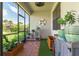 Cozy screened porch with brick floors and lush potted plants, perfect for relaxation at 7683 Summerland Cv, Lakewood Ranch, FL 34202