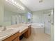 Bathroom boasts a soaking tub, separate shower, double sinks, and a large mirror at 8222 Haven Harbour Way, Bradenton, FL 34212