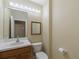 Simple bathroom with a vanity, toilet, and mirror, offering functionality and cleanliness at 8222 Haven Harbour Way, Bradenton, FL 34212