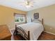 Cozy bedroom with wood floors, ceiling fan, and a metal frame bed at 8222 Haven Harbour Way, Bradenton, FL 34212