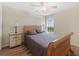 Comfortable bedroom featuring a wood frame bed and a window at 8222 Haven Harbour Way, Bradenton, FL 34212
