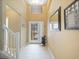 Bright entryway with high ceilings, tiled floors, neutral paint, and a glass-paneled door with a view of the outdoors at 8222 Haven Harbour Way, Bradenton, FL 34212