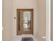 Close-up of a front door featuring a glass panel, a brown frame, and modern door hardware at 8222 Haven Harbour Way, Bradenton, FL 34212