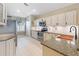 Well-lit kitchen featuring granite countertops, stainless steel appliances, neutral-colored cabinets, and tile backsplash at 8222 Haven Harbour Way, Bradenton, FL 34212