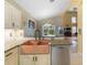 Featuring a stainless steel dishwasher and a copper sink, this kitchen is ready for entertaining at 8222 Haven Harbour Way, Bradenton, FL 34212