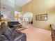 Expansive living room with hardwood floors, soaring ceilings, and an open layout connecting to the kitchen at 8222 Haven Harbour Way, Bradenton, FL 34212