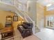 Bright living room featuring an open floor plan, soaring ceilings, wood flooring, staircase, and elegant decor at 8222 Haven Harbour Way, Bradenton, FL 34212
