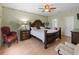 Spacious main bedroom featuring hardwood floors, a ceiling fan, and a large bed at 8222 Haven Harbour Way, Bradenton, FL 34212